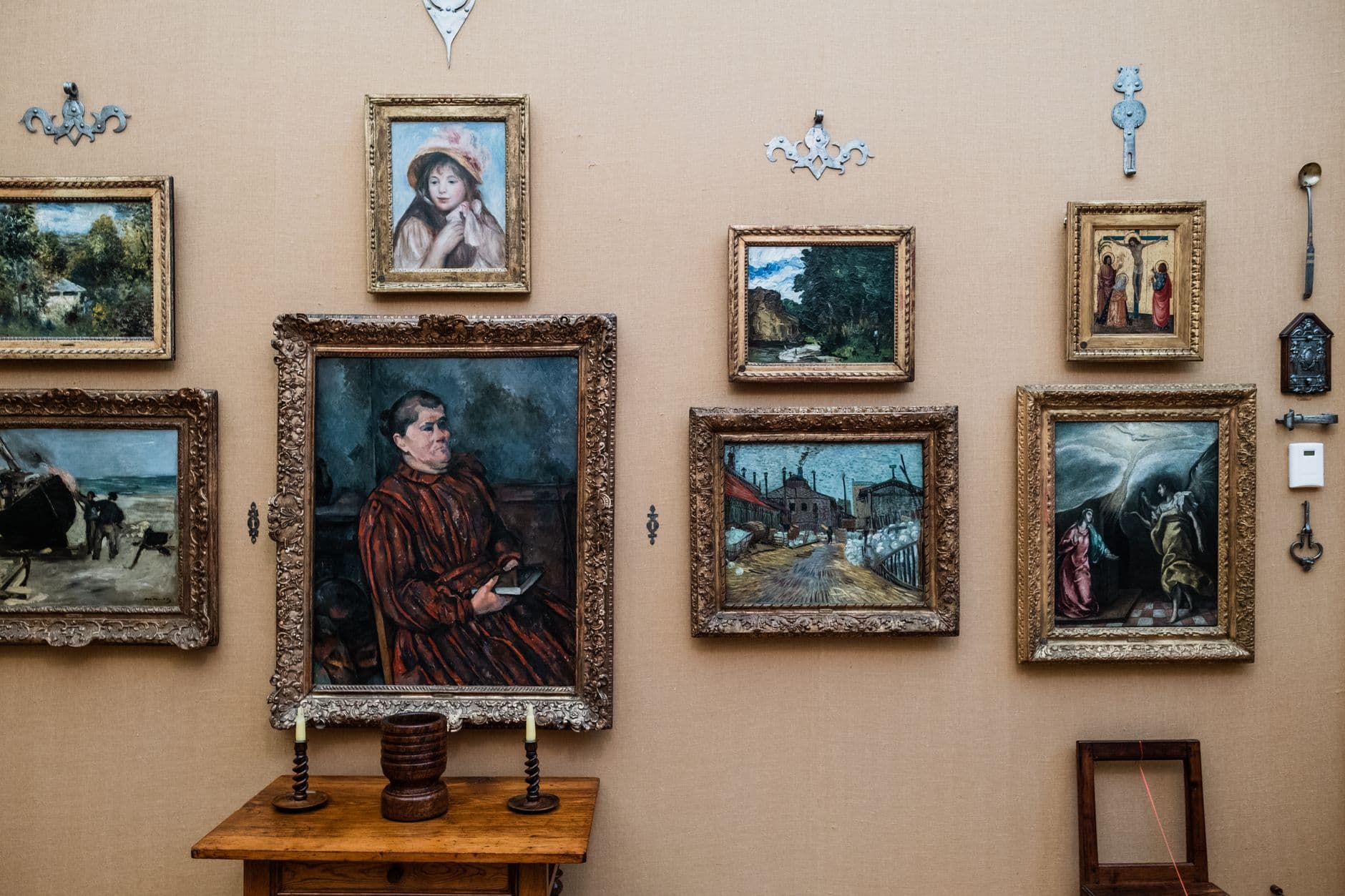 Framed portraits hung on a warm gallery wall